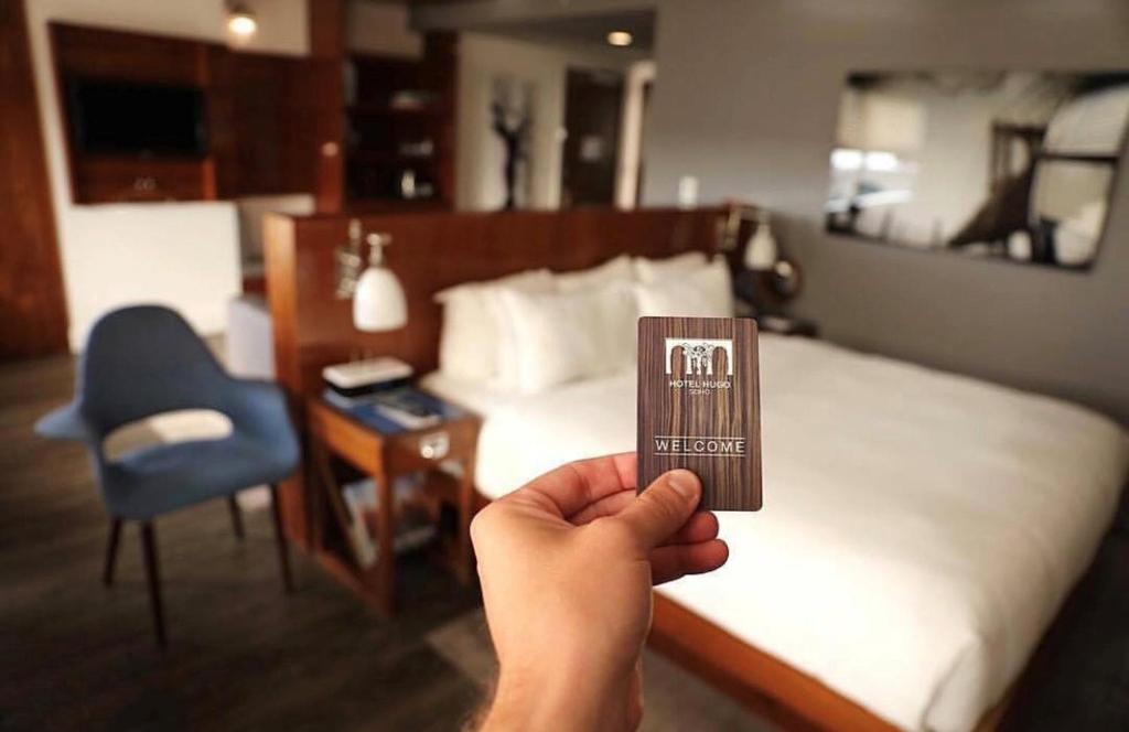 Postel nebo postele na pokoji v ubytování Hotel Hugo