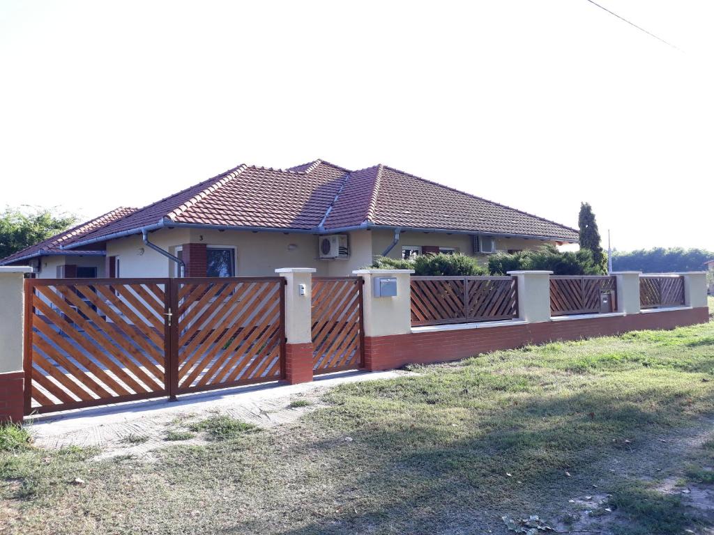 a fence in front of a house at Bella Vendégház Mórahalom in Mórahalom