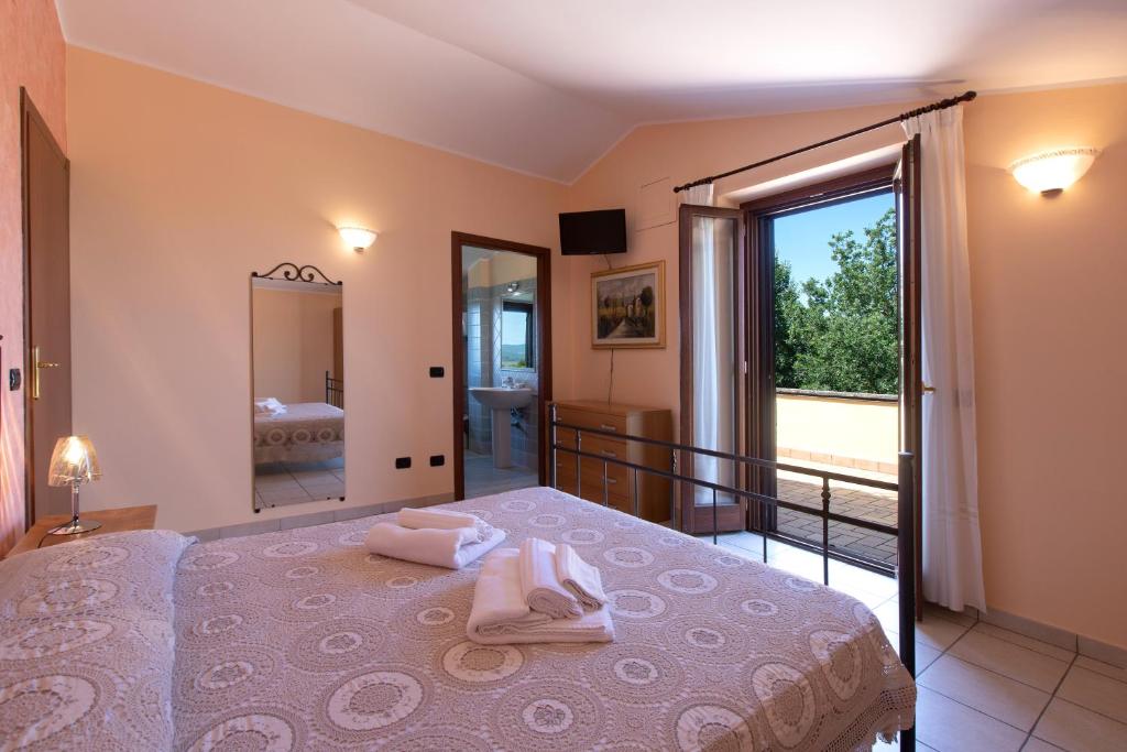 Postel nebo postele na pokoji v ubytování B&B La Casa Fra Gli Olivi