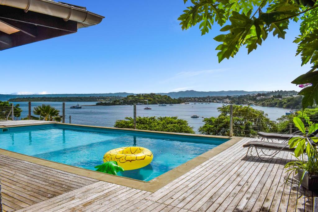 a swimming pool with a view of the water at Harbour Views in Port Vila