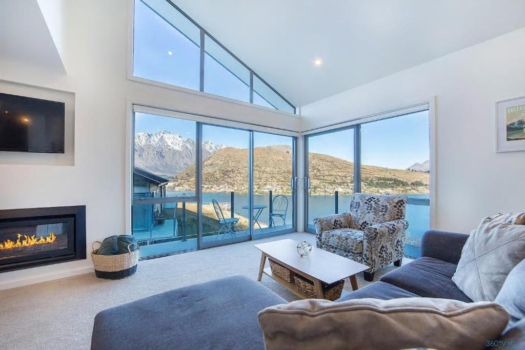 a living room with a couch and a fireplace at Executive Living in Bluewater - 3 Bedroom Apartment in Queenstown
