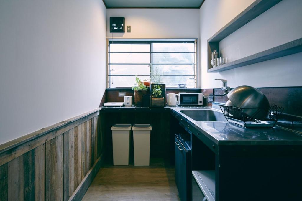 a kitchen with a sink and a counter top at kagelow Mt.Fuji Hostel Kawaguchiko in Fujikawaguchiko