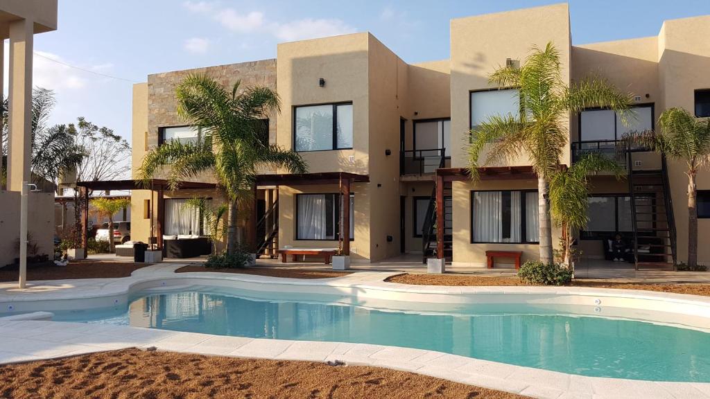 a building with a swimming pool in front of a building at Complejo Anjana in Federación