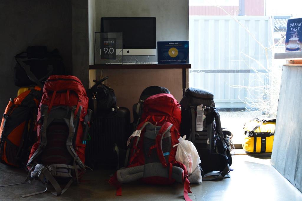 a bunch of backpacks are lined up in a room at kagelow Mt.Fuji Hostel Kawaguchiko in Fujikawaguchiko