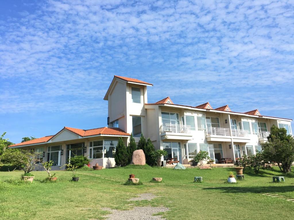 a large building with a lot of animals in the yard at Coral B&B in Hengchun South Gate