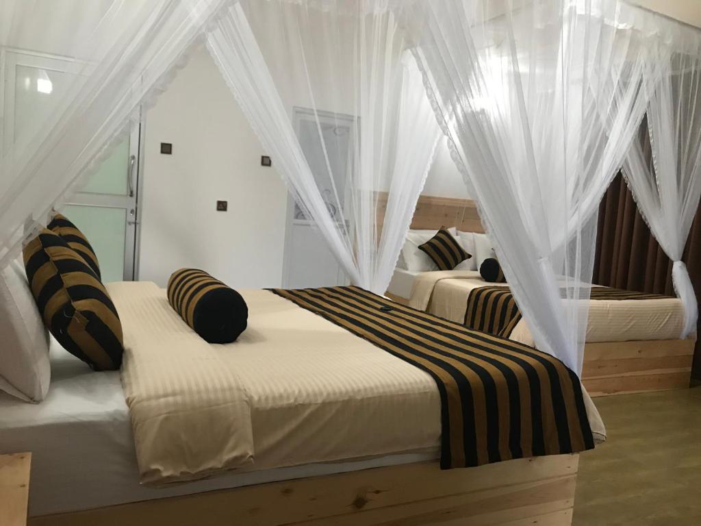 Postel nebo postele na pokoji v ubytování Rawana View Ella