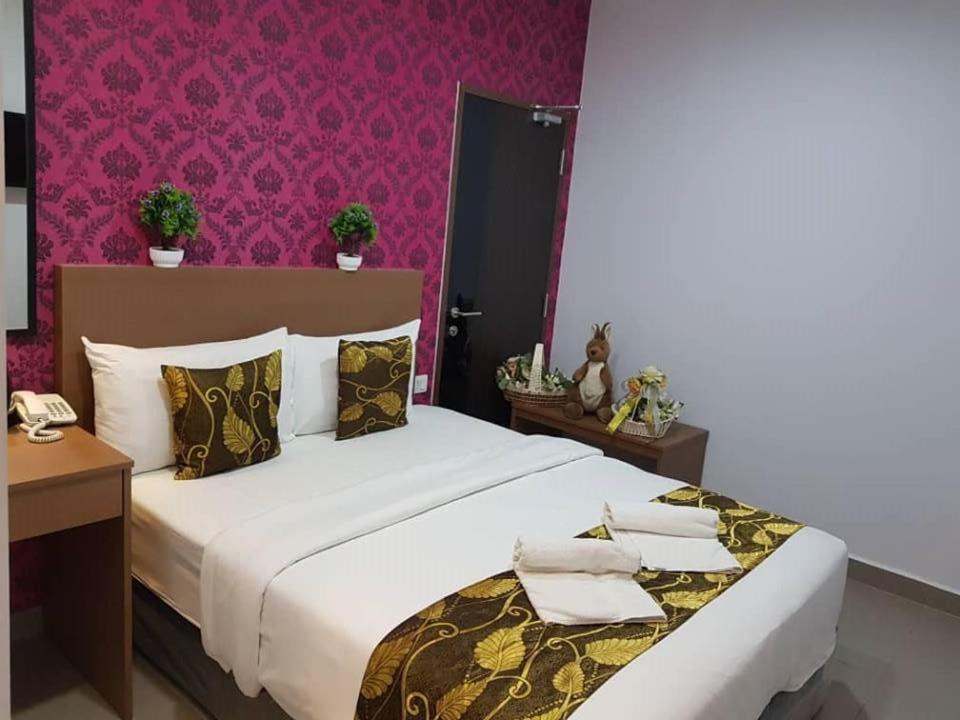 Postel nebo postele na pokoji v ubytování D'Metro Hotel