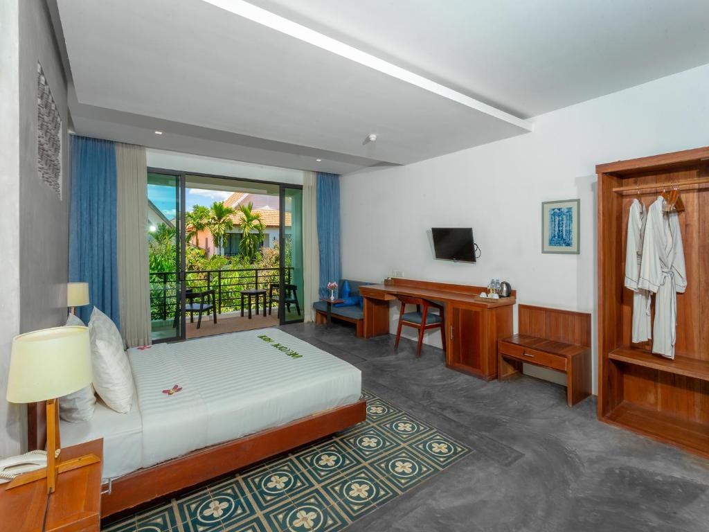 Postel nebo postele na pokoji v ubytování Tanei Angkor Resort and Spa