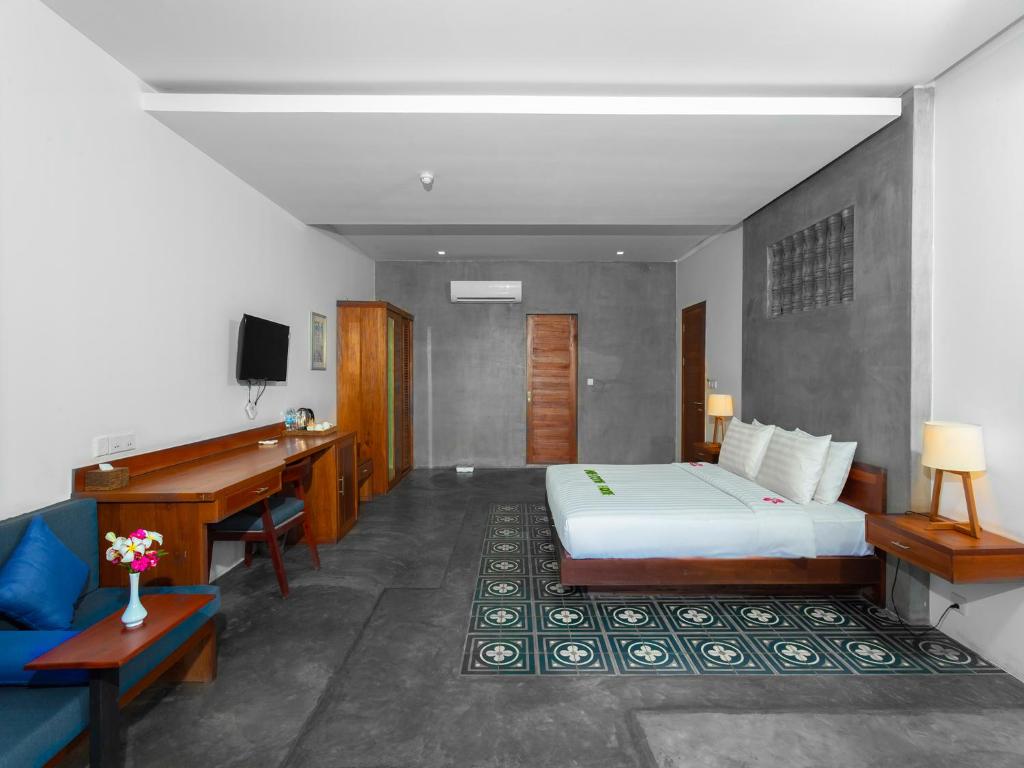 Postel nebo postele na pokoji v ubytování Tanei Angkor Resort and Spa