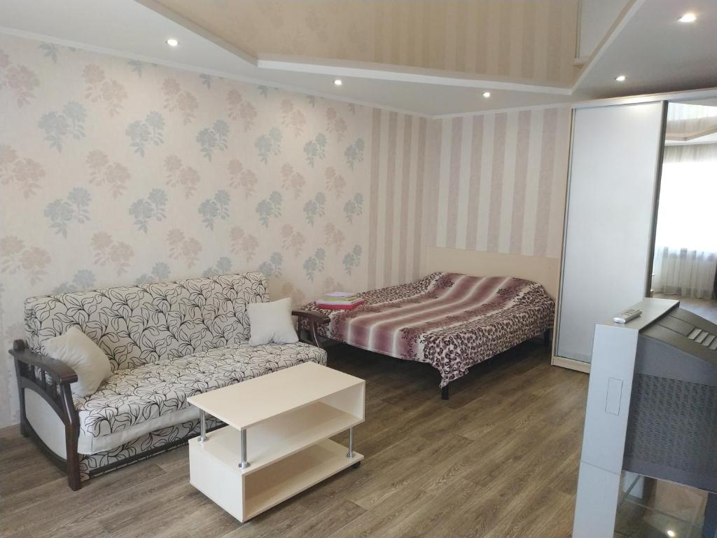 a living room with a couch and a bed at Apartment at Kirova (A.Polia) in Dnipro