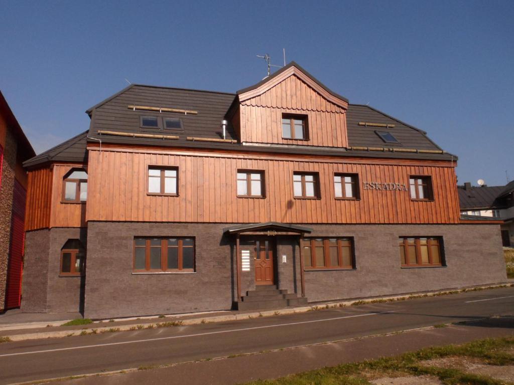 a large wooden building with a door on a street at Apartmán Eskadra 02 in Horní Malá Úpa