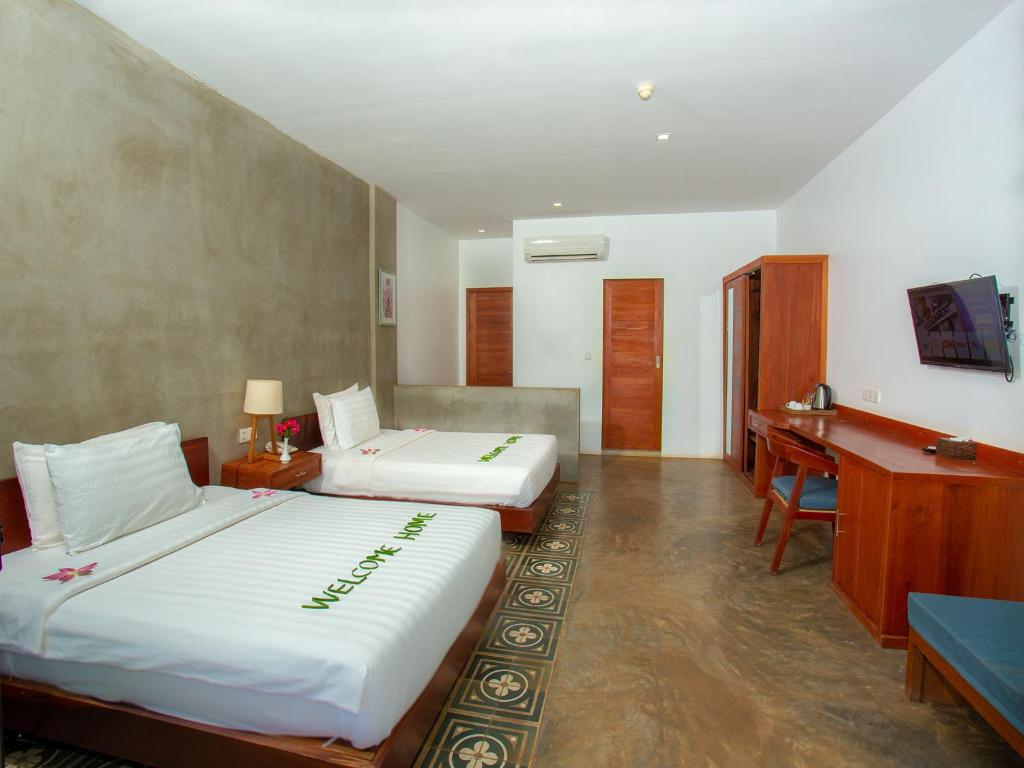 Postel nebo postele na pokoji v ubytování Tanei Angkor Resort and Spa