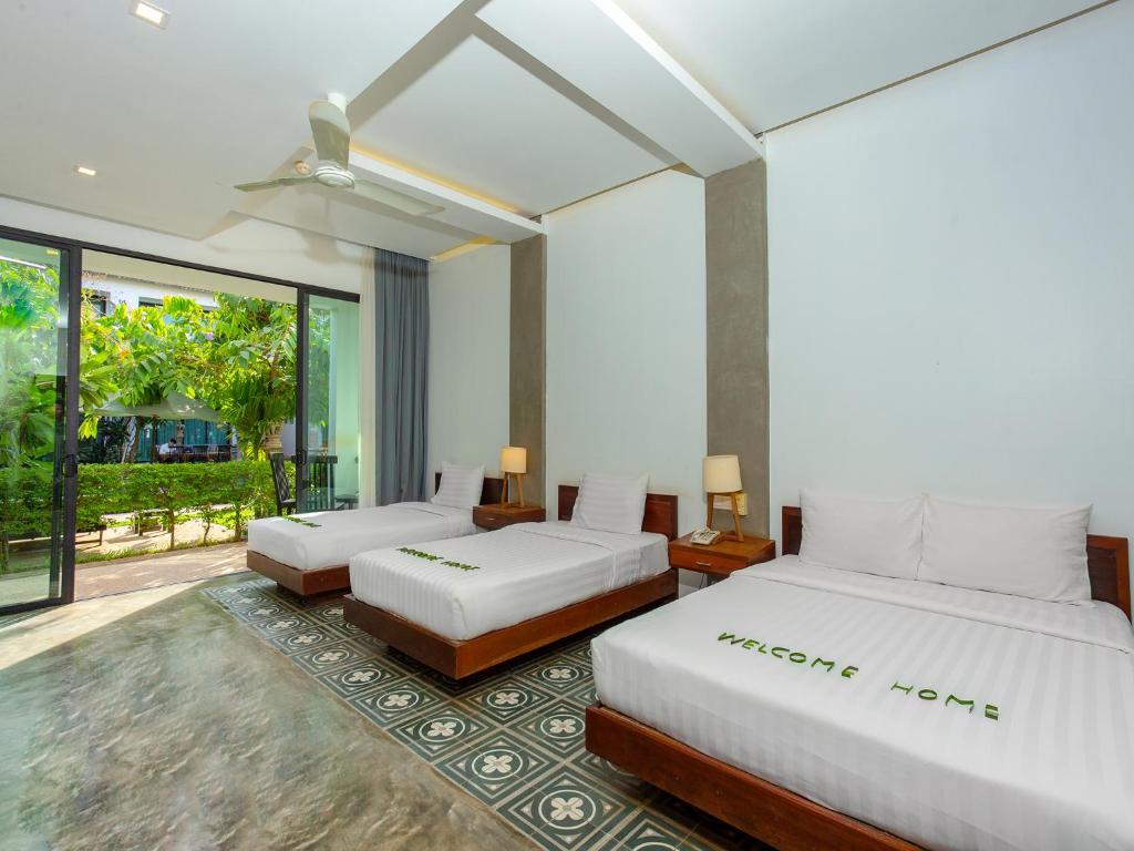 Postel nebo postele na pokoji v ubytování Tanei Angkor Resort and Spa