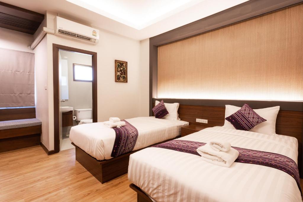 En eller flere senge i et værelse på Lima Lanna Hotel