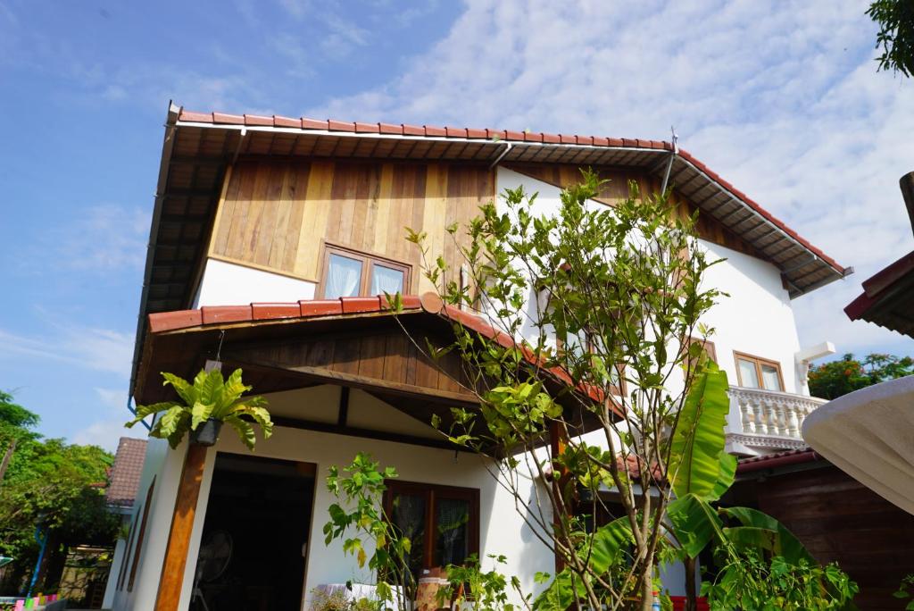 a house with a wooden roof at ANGKOR DINO B&B in Siem Reap