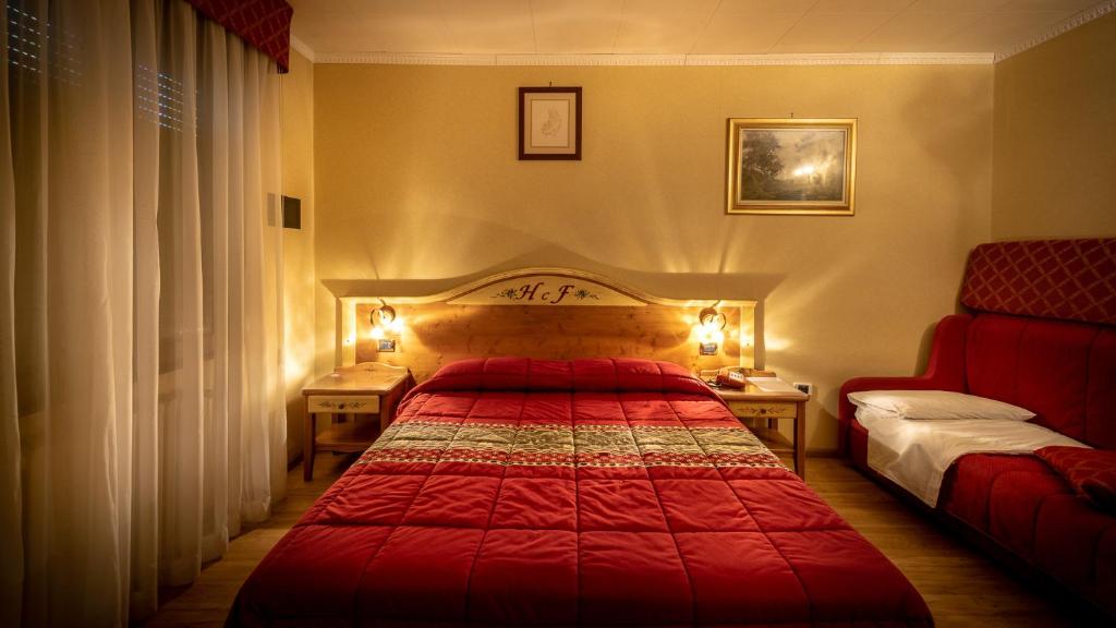 Postel nebo postele na pokoji v ubytování Hotel Club Funivia