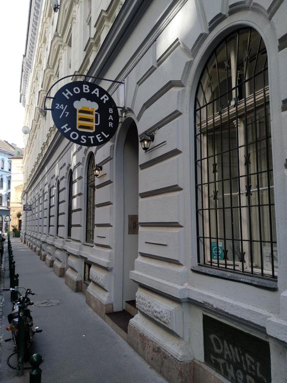 a building with a sign on the side of it at HoBar Hostel in Budapest