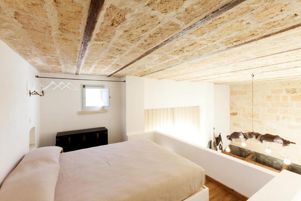 Postel nebo postele na pokoji v ubytování Masseria Borgo Mortella