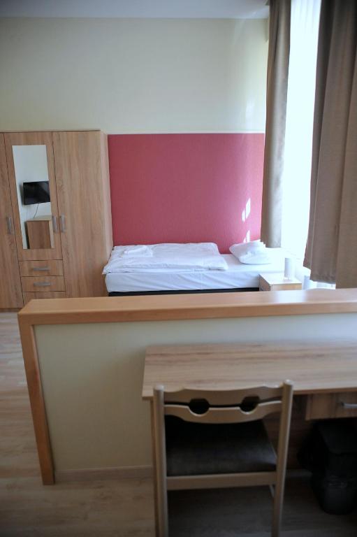 Postel nebo postele na pokoji v ubytování Piros Arany Panzió Kalocsa