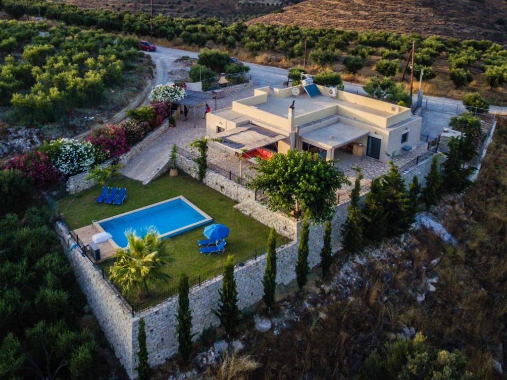 an aerial view of a house with a swimming pool at Villa Diana in Pitsidia