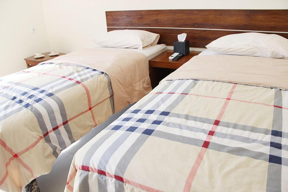 Postel nebo postele na pokoji v ubytování Bamboe Inn Homestay