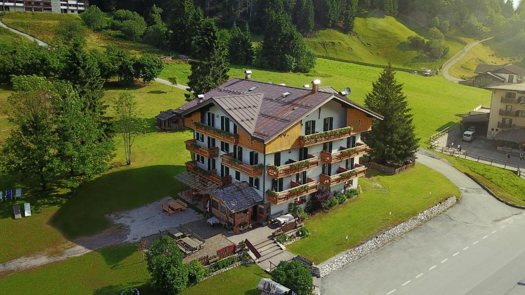 an overhead view of a large house on a green field at Rifugio Cereda in Fiera di Primiero