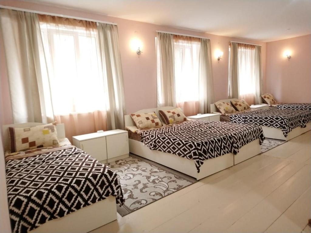 two beds in a room with windows at Guest house in Alaverdi in Alaverdi