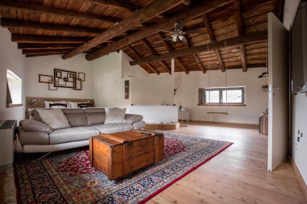 a living room with a couch and a coffee table at foresteria stazzona in Villa di Tirano
