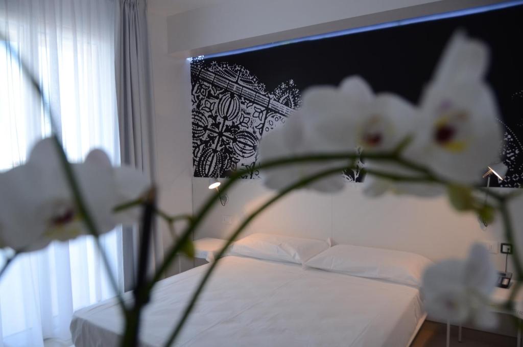 Postel nebo postele na pokoji v ubytování QuiHotel