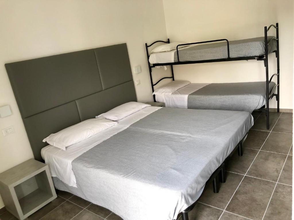 Postel nebo postele na pokoji v ubytování Hotel Eugenio