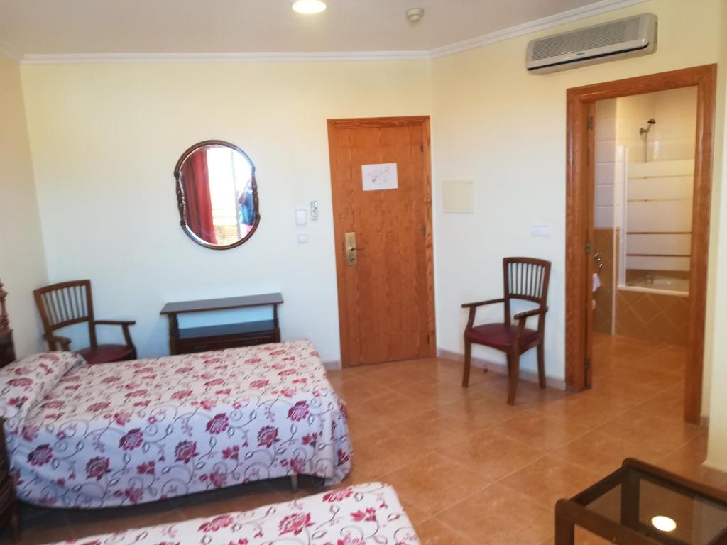 Postel nebo postele na pokoji v ubytování Hotel Paloma
