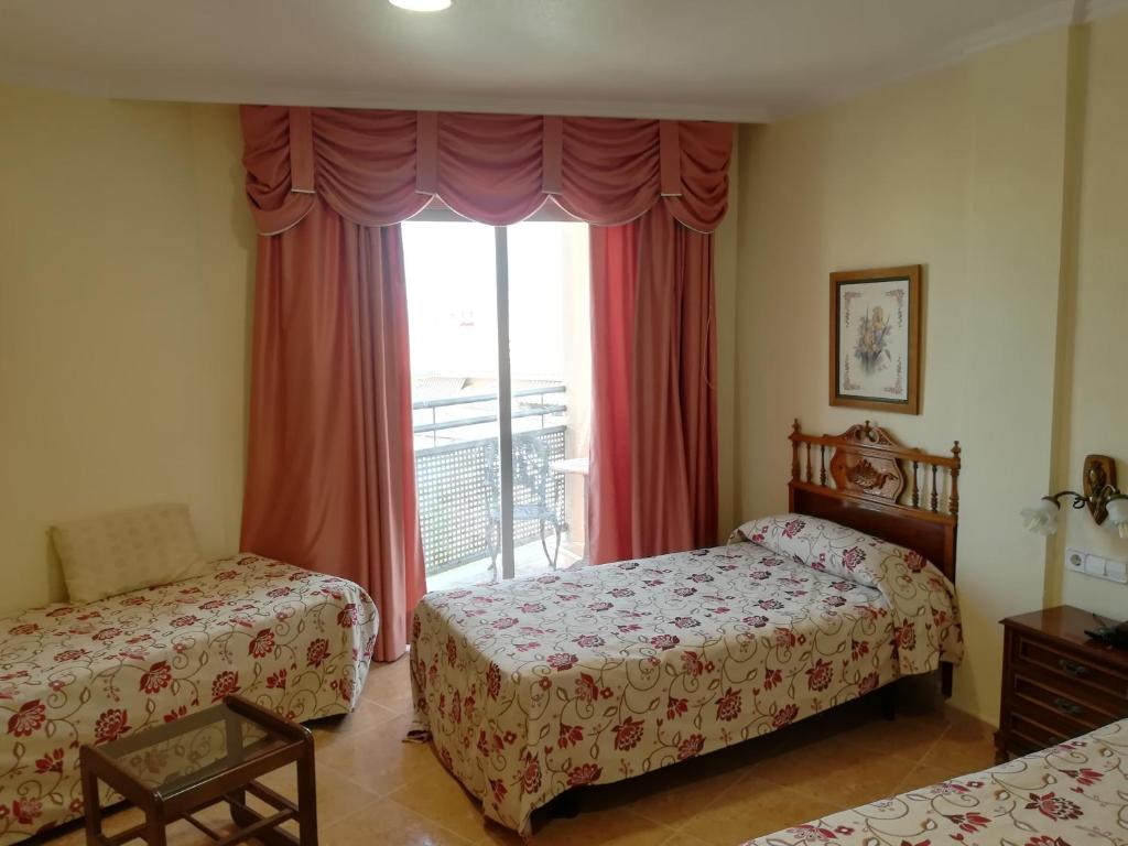 Postel nebo postele na pokoji v ubytování Hotel Paloma