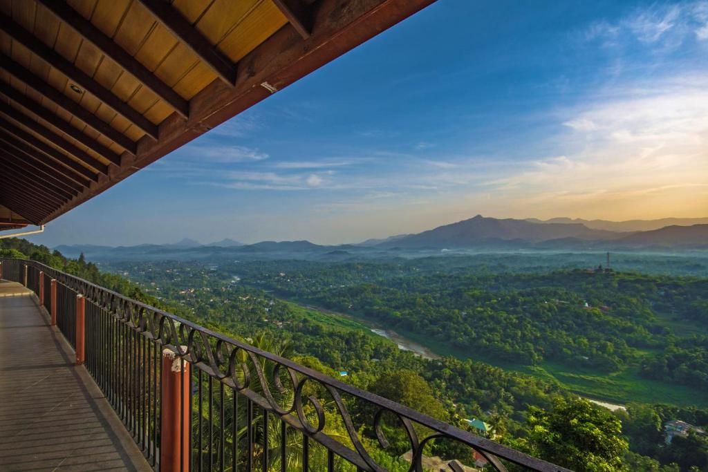a view from a balcony of a valley with mountains at Ceyloni Panorama Resort in Kandy