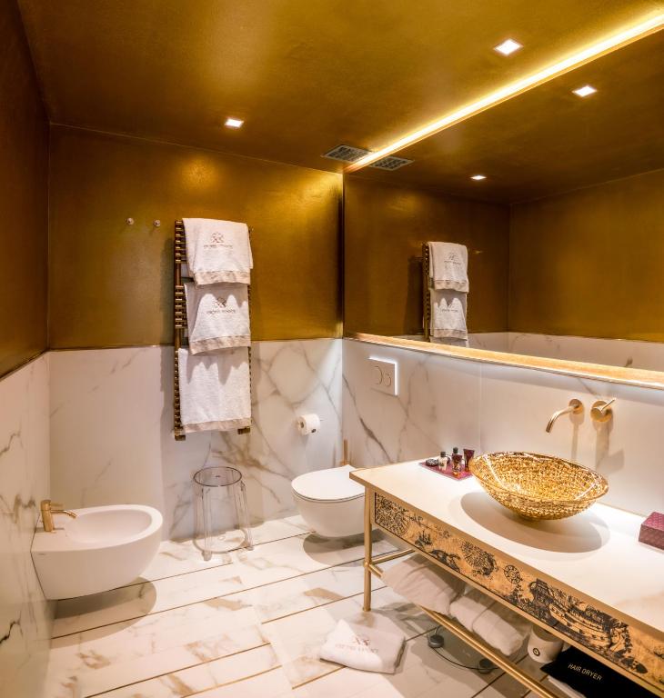 a bathroom with a sink and a toilet at Excess Venice Boutique Hotel & Private Spa - Adults Only in Venice