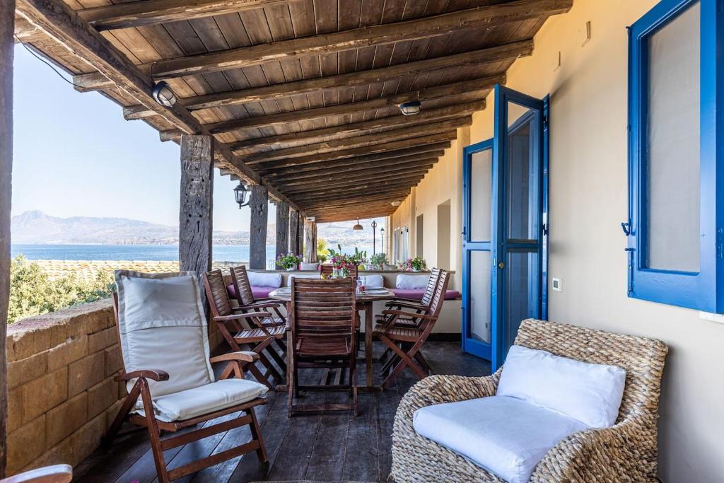 a porch with chairs and a table with a view at Vero Sicily - Casa Sapore di Mare in Santa Flavia