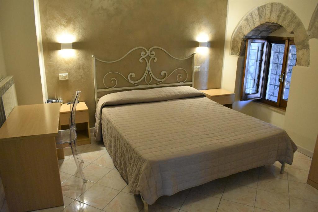 Postel nebo postele na pokoji v ubytování Camere Santa Chiara