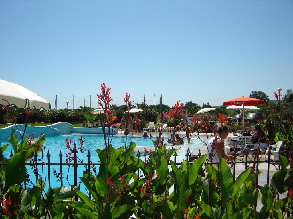 a large swimming pool with people in the water at Elena Club Resort in Silvi Marina