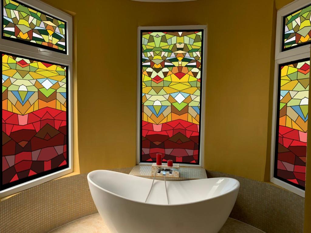 a bathroom with a tub and stained glass windows at Hotello in Tbilisi City