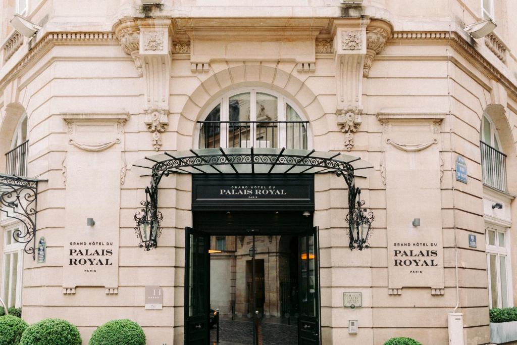 a building with the entrance to a paris hotel at Grand Hôtel Du Palais Royal in Paris