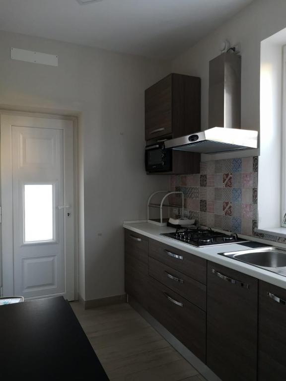 a kitchen with a sink and a stove top oven at CASA GIULIETTA in Vico Equense