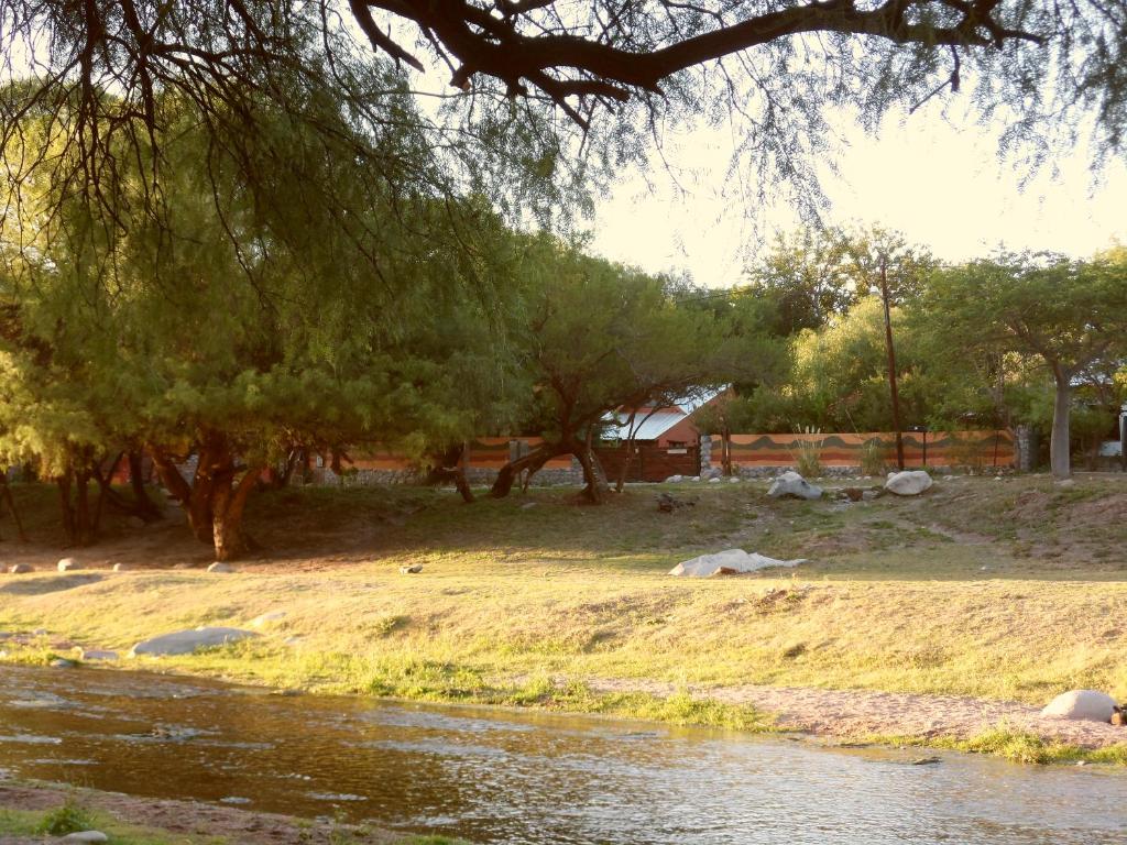 a group of trees and a body of water at CABAÑAS DE LA QUEBRADA in San Marcos Sierras