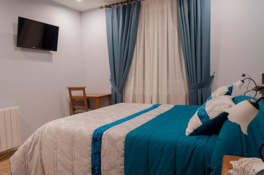 Posteľ alebo postele v izbe v ubytovaní Hostal Tribal