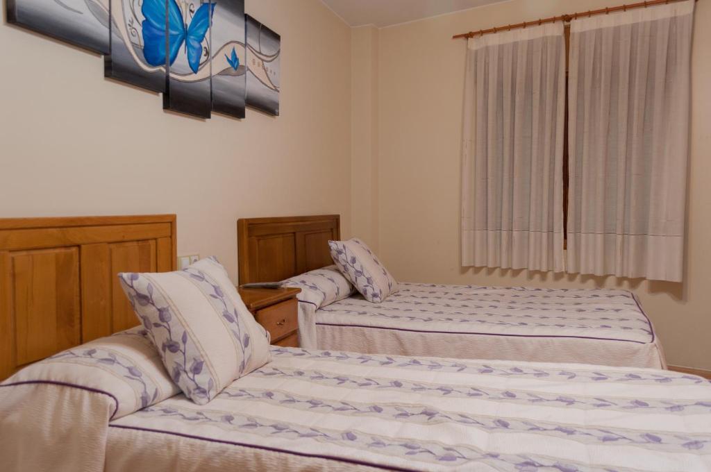Posteľ alebo postele v izbe v ubytovaní Hostal Tribal