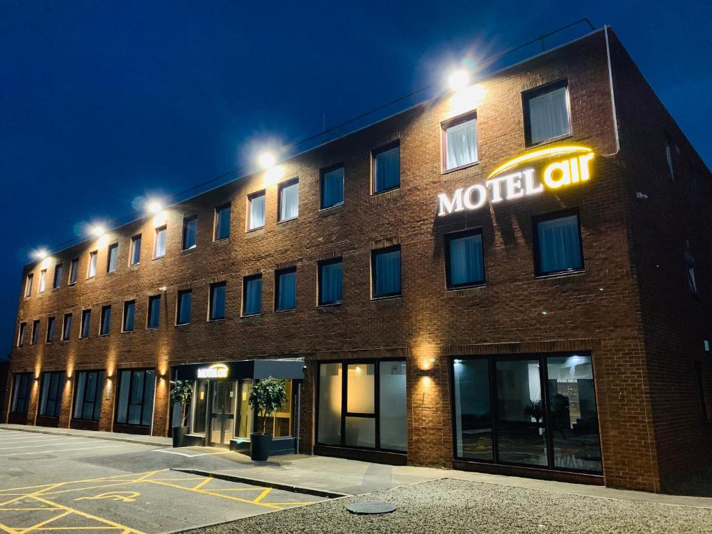 a brick building with a motel oil sign on it at Motel Air Glasgow Airport in Paisley