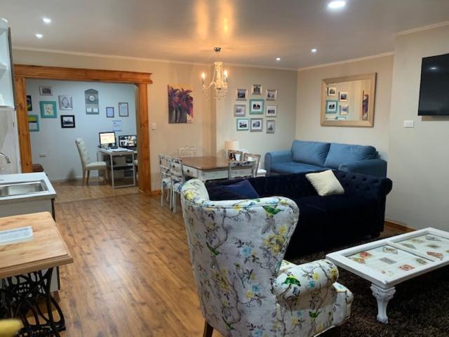 a living room with a couch and a table at Hostel Chaman in Osorno