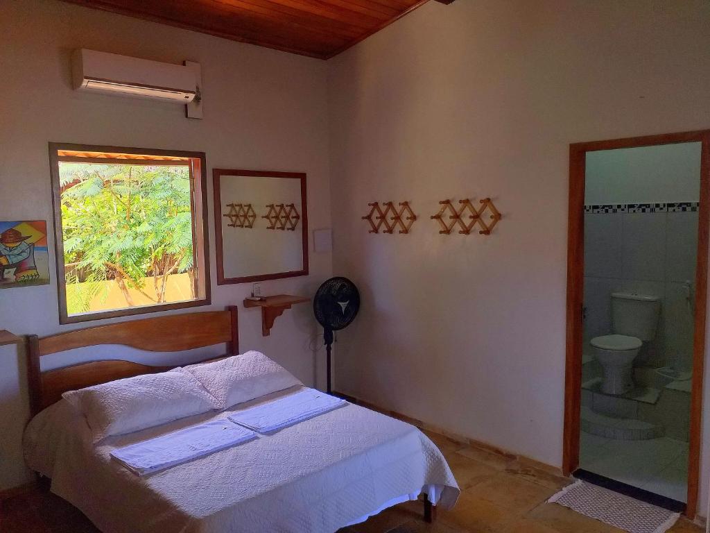 A bed or beds in a room at Pousada Sahara