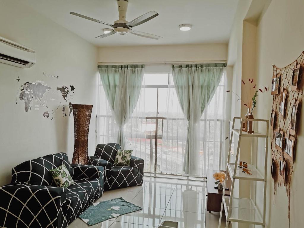 a living room with a couch and a window at Taiping Centre Point Suite 7 by BWC in Taiping