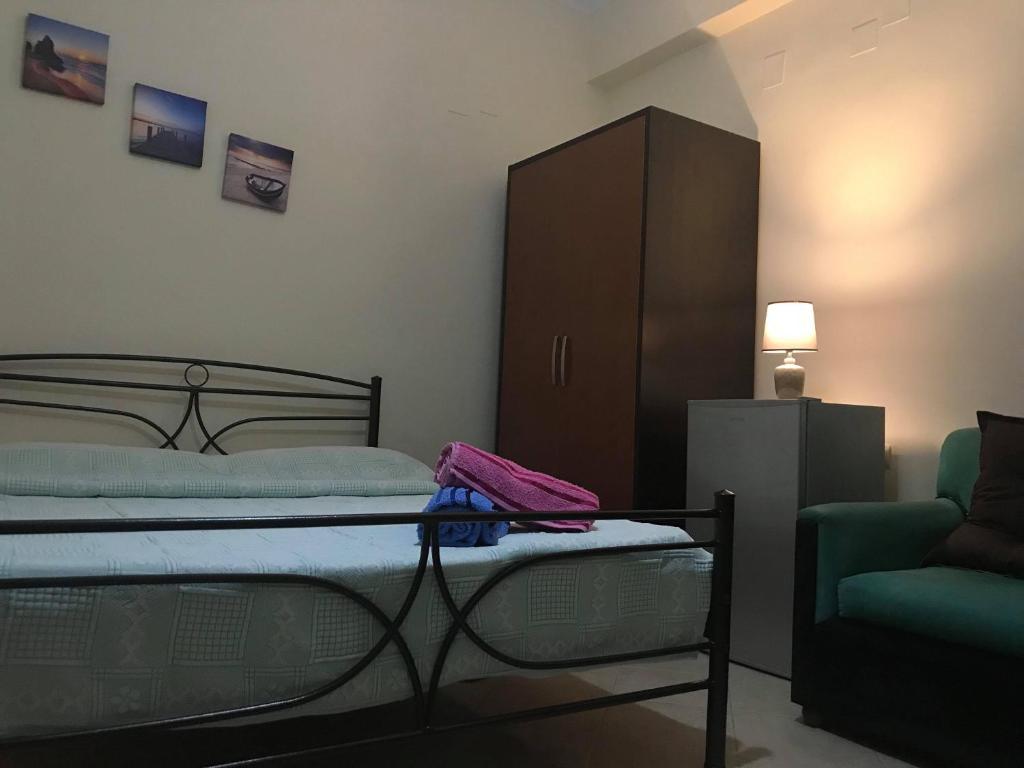 a bedroom with a bed and a cabinet and a chair at Joni's house in Piqeras