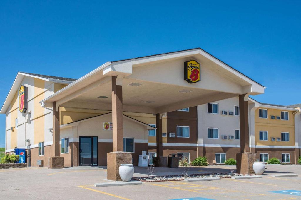 a hotel with a sign on the front of a building at Super 8 by Wyndham Gillette in Gillette