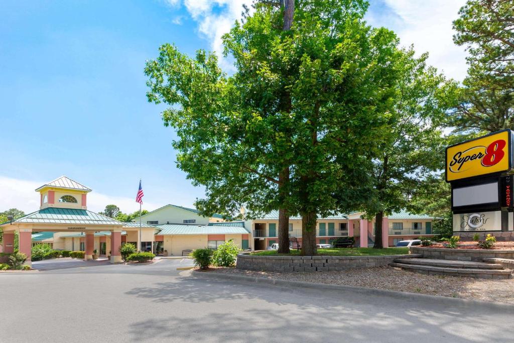 a building with a tree in front of it at Super 8 by Wyndham Eureka Springs in Eureka Springs